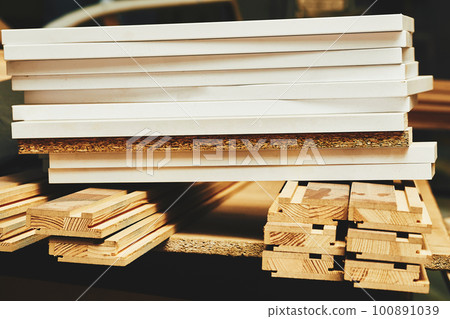 Sheets of plywood, boards, lumber stacked in rows in a carpentry in a warehouse Sheets of plywood, boards, lumber stacked in rows in a carpentry in a warehouse 100891039