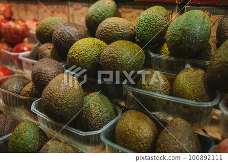 Brown ripe avocados in basket for sale at fruit stall in the market Brown ripe avocados in basket for sale at fruit stall in the market 100892111