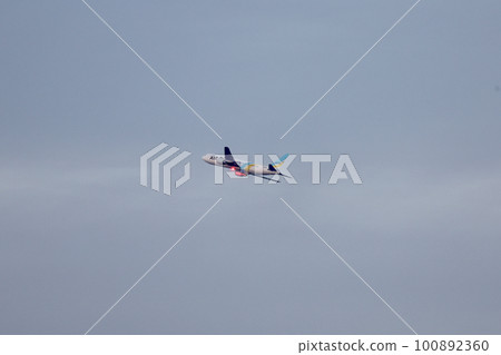 An airplane flying over the sky 100892360