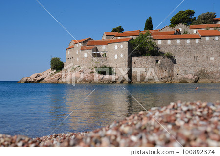 Beautiful empty beach near Sveti Stefan island at sunny summer day in Montenegro. Beautiful empty beach near Sveti Stefan island at sunny summer day in Montenegro. 100892374