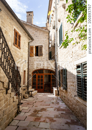 Colorful street in the old town of Kotor on a sunny day, Montenegro. Travel, vacation, walk. 100893767