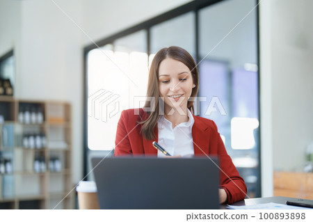 financial, Planning, Marketing and Accounting, portrait of Asian employee checking financial statements using documents and calculators at work.. 100893898