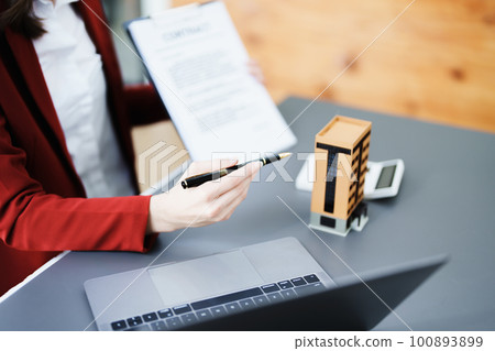 Guarantee, mortgage, agreement, contract, signed, real estate agent pointing to documents for customers to read the agreement before signing important documents. Guarantee, mortgage, agreement, contract, signed, real estate agent pointing to documents for customers to read the agreement before signing important documents. 100893899