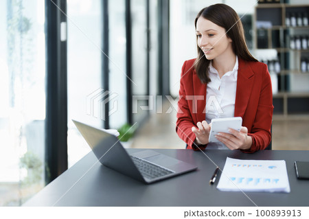 Accountants, Asian auditors are using calculators and computers to review annual tax budgets to submit information to the IRS 100893913