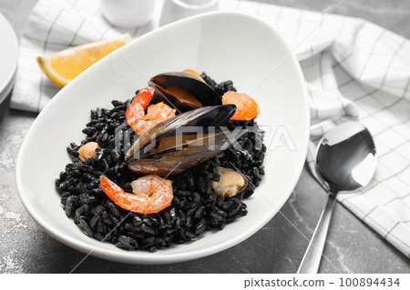 Delicious black risotto with seafood on marble table 100894434