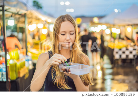 Young woman tourist on Walking street Asian food market Young woman tourist on Walking street Asian food market 100895189