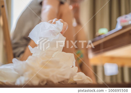 A pile of napkins are near the woman, seasonal snot 100895508