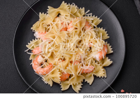 Delicious farfalle pasta with langoustine shrimp with creamy sauce 100895720