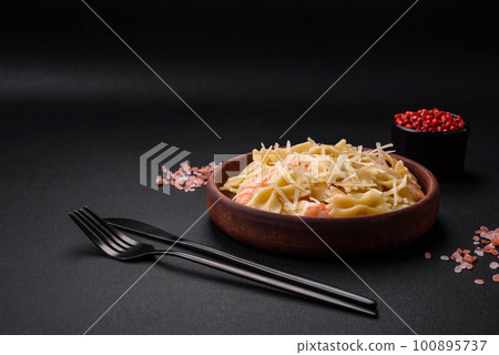 Delicious farfalle pasta with langoustine shrimp with creamy sauce 100895737