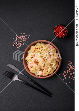 Delicious farfalle pasta with langoustine shrimp with creamy sauce 100895738