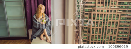 Woman wrapped in a blanket and looking at the big city BANNER, LONG FORMAT Woman wrapped in a blanket and looking at the big city BANNER, LONG FORMAT 100896019