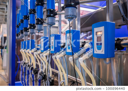 Automated goat milking suction machine with teat cups at exhibition Automated goat milking suction machine with teat cups at exhibition 100896440