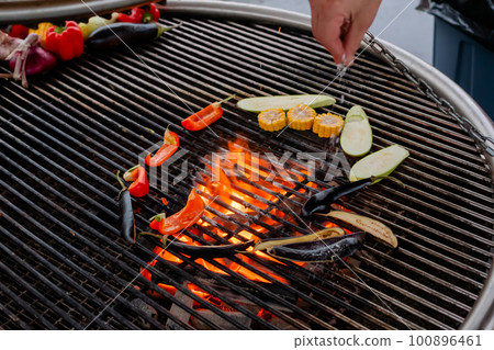 Process of grilling healthy vegetables - pepper, corn, zucchini, eggplant slices Process of grilling healthy vegetables - pepper, corn, zucchini, eggplant slices 100896461