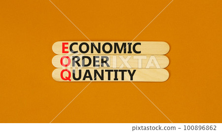 EOQ economic order quantity symbol. Concept words EOQ economic order quantity on wooden stick on a beautiful orange table orange background. Business EOQ economic order quantity concept. Copy space. 100896862