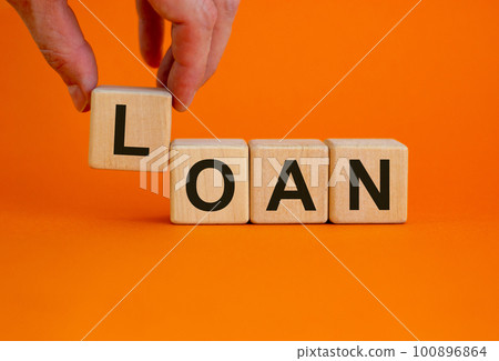 Concept word 'loan' on cubes on a beautiful orange background. Male hand. Business concept. Copy space. 100896864