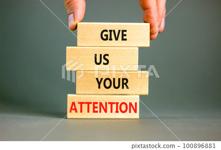 Give us your attention symbol. Concept words Give us your attention on wooden block. Beautiful grey table grey background. Motivational business give us your attention concept. Copy space. 100896881