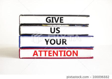 Give us your attention symbol. Concept words Give us your attention on books. Beautiful white table white background. Motivational business give us your attention concept. Copy space. 100896882
