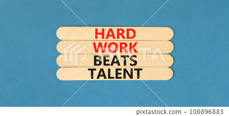 Hard work beats talent symbol. Concept words Hard work beats talent on wooden stick. Beautiful blue table blue background. Motivational business hard work beats talent concept. Copy space. 100896883