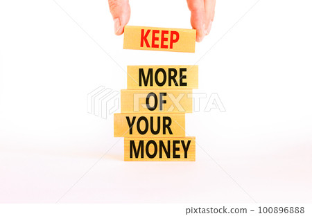 Keep more of your money symbol. Concept words Keep more of your money on wooden block. Beautiful white table white background. Businessman hand. Business keep more of your money concept. Copy space. Keep more of your money symbol. Concept words Keep more of your money on wooden block. Beautiful white table white background. Businessman hand. Business keep more of your money concept. Copy space. 100896888