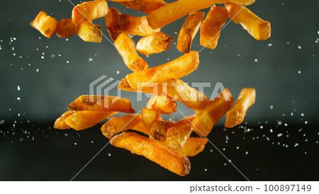 Freeze Motion Shot of Falling Fresh French Fries, Close-up Freeze Motion Shot of Falling Fresh French Fries, Close-up 100897149