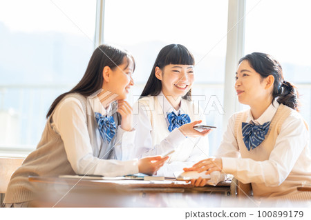 High school girls chatting in the classroom 100899179