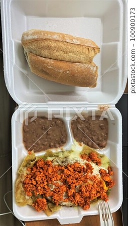 Mexican breakfast chilaquiles rojos con chorizo, huevo and bolillo Mexican breakfast chilaquiles rojos con chorizo, huevo and bolillo 100900173