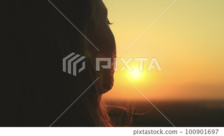 beautiful girl sunset with tousled hair. portrait girl at sunset. girl hair develops wind sunlight. Girl dream pray hair sunset dawn sky sun. youth ask help wind journey vintage. training organic 100901697