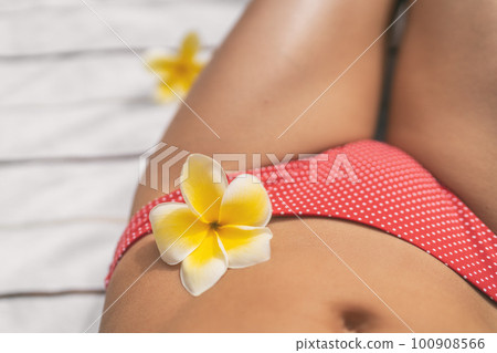 Woman legs bikini body care with flower at panties -feminine care wellness - gynecology, intimate women hygiene products for menstruation and genital health Woman legs bikini body care with flower at panties -feminine care wellness - gynecology, intimate women hygiene products for menstruation and genital health 100908566