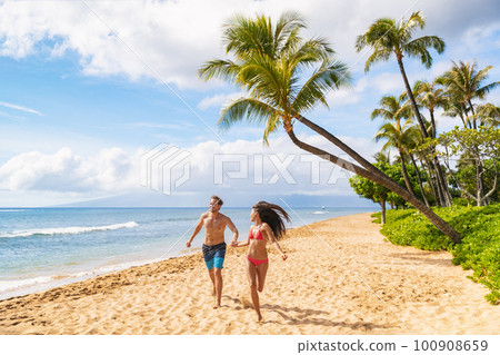 Happy Hawaii beach fun young people running enjoying summer vacations in Maui, Kaanapali beach, USA travel lifestyle Happy Hawaii beach fun young people running enjoying summer vacations in Maui, Kaanapali beach, USA travel lifestyle 100908659
