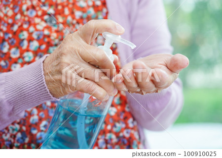 Asian senior woman press blue alcohol sanitizer gel for washing hand protect infection coronavirus. 100910025