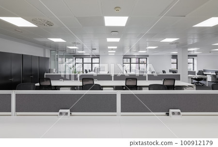 Panorama of an empty office with tables and chairs in gray tones after renovation ready to create coworking jobs. The concept of creative space in the city and affordable office rent 100912179