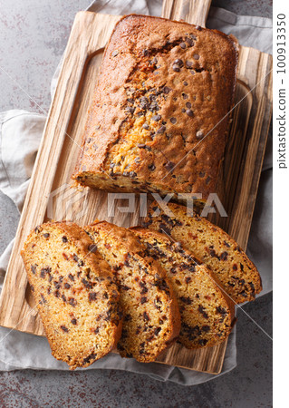 Aromatic halloween Pumpkin Chocolate Chip Bread as traditional and seasonal cuisine closeup on the wooden board. Vertical top view Aromatic halloween Pumpkin Chocolate Chip Bread as traditional and seasonal cuisine closeup on the wooden board. Vertical top view 100913350