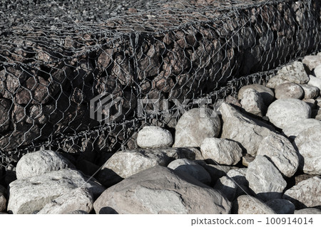 Gabion and rough stones at the roadside Gabion and rough stones at the roadside 100914014