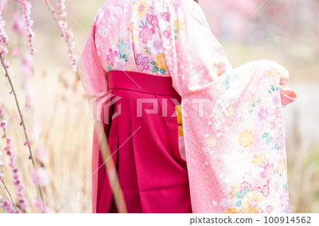 早春，一名身著日式服裝的女子在垂枝梅前擺姿勢 100914562