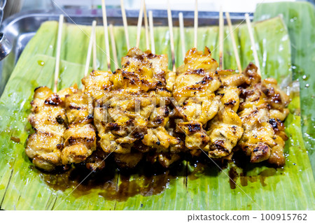 Moo Ping or Pork satay, is popular street food in Thailand. Moo Ping or Pork satay, is popular street food in Thailand. 100915762