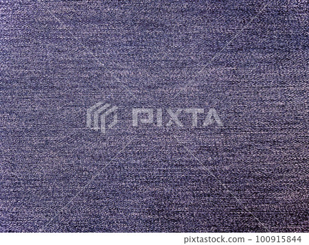 A background image with a texture of bright purple blue plain denim fabric A background image with a texture of bright purple blue plain denim fabric 100915844