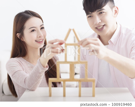 Happy young couple building house by with wooden Happy young couple building house by with wooden 100919460