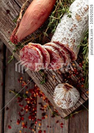 Dry-cured sausage on a old wooden table. 100920026