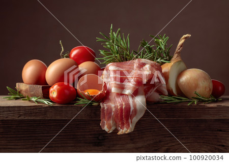Smoked bacon with eggs, tomatoes, onions and rosemary. Smoked bacon with eggs, tomatoes, onions and rosemary. 100920034