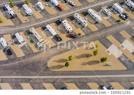An aerial view of park where recreational vehicles are parked and RVs are on vacation An aerial view of park where recreational vehicles are parked and RVs are on vacation 100921291