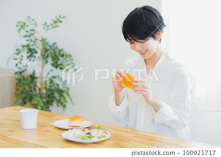 A young woman eating breakfast A young woman eating breakfast 100921717