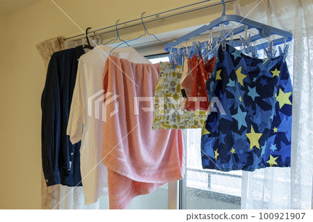 Laundry drying indoors by the window Laundry drying indoors by the window 100921907