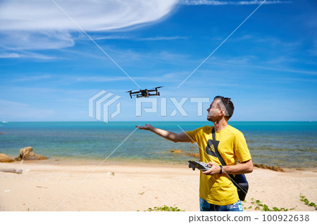 A guy launches from the arm of a prone on the seashore 100922638