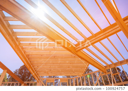 An underlying framing beam provides support for layout of joists in newly constructed wooden structure. 100924757