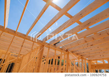 Wooden framework was carried during construction house, consisting of beams joists trusses 100924758