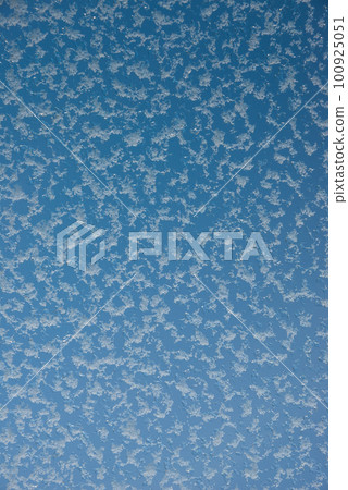 Cover page with frosty and snowy icy glass window at winter snowy day. Concept of seasonal mood, blue sky gradient background with copy space. Cover page with frosty and snowy icy glass window at winter snowy day. Concept of seasonal mood, blue sky gradient background with copy space. 100925051
