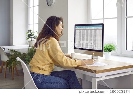 Young woman accountant working at her home office and using spreadsheets on the computer Young woman accountant working at her home office and using spreadsheets on the computer 100925174