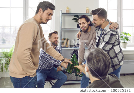 Group of happy male friends hanging out, drinking beer, clinking bottles, and having fun Group of happy male friends hanging out, drinking beer, clinking bottles, and having fun 100925181