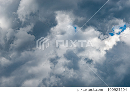 Dramatic rainy and stormy sky with heavy clouds as a background. Dramatic rainy and stormy sky with heavy clouds as a background. 100925204
