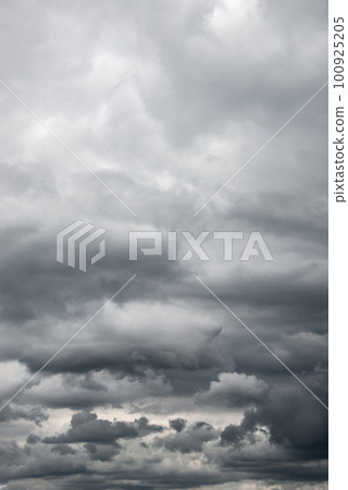 Cover page with dramatic rainy and stormy sky with heavy clouds as a background with copy space. 100925205